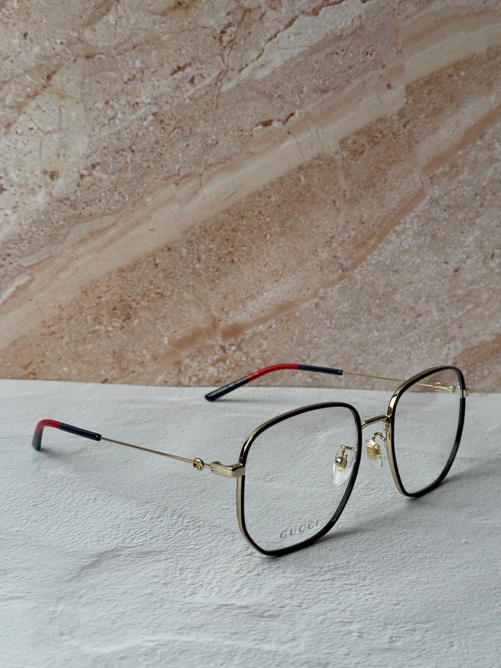 Gucci square eyeglasses in black with gold hinges and red temple lining