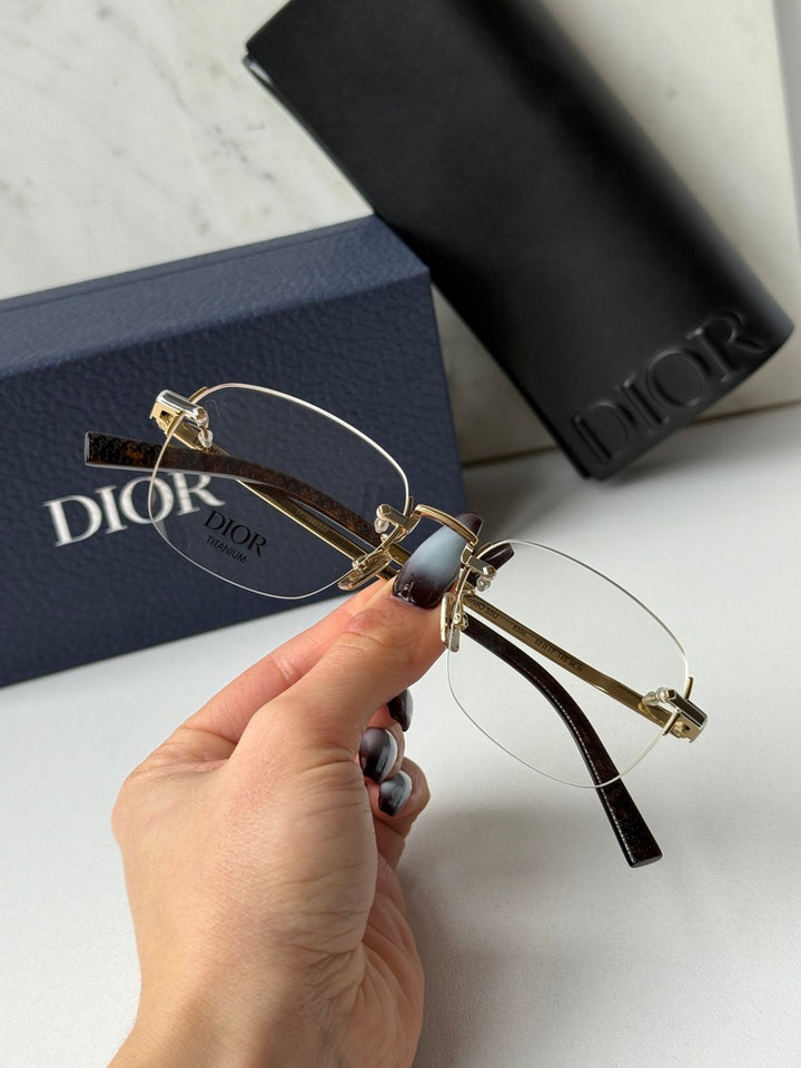 DIOR rimless eyeglasses close-up with two-tone metal temple and clear lenses