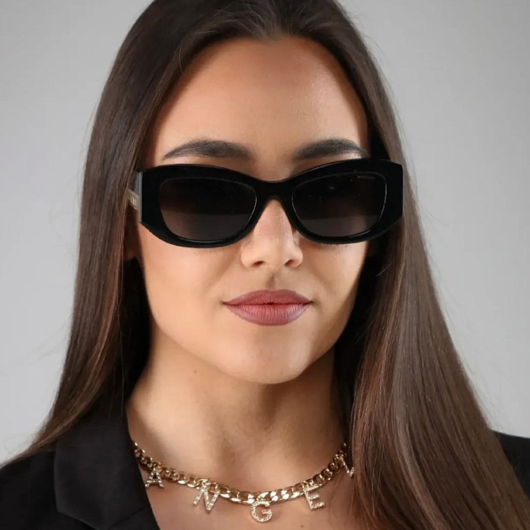 Black square sunglasses on a woman with dark lenses and slim temples