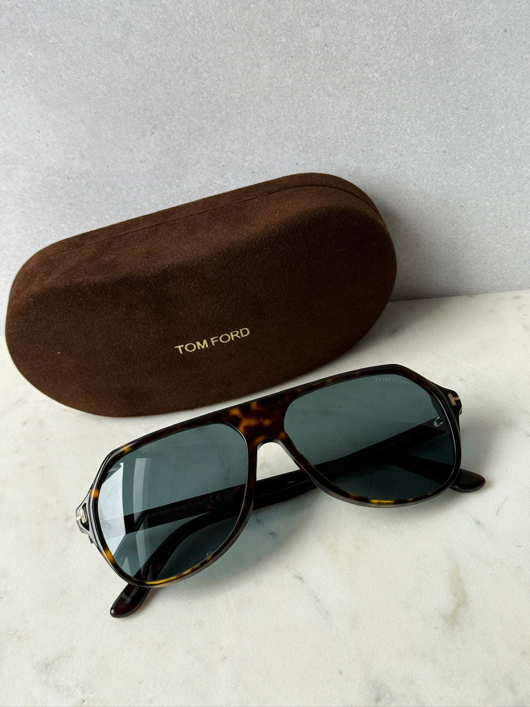 Aviator sunglasses with dark Havana frame and green tinted lenses, with brown case