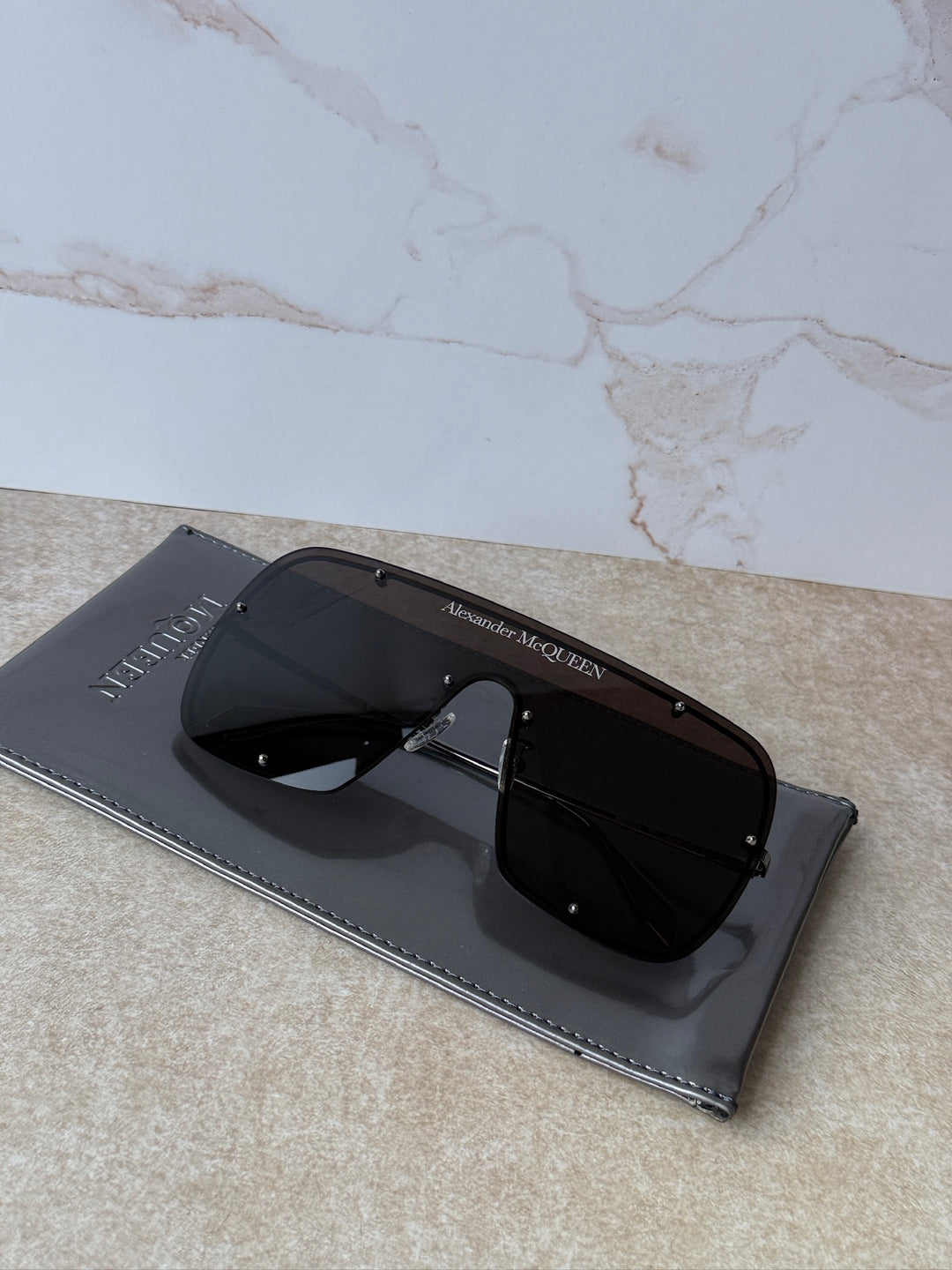 Oversized studded mask sunglasses with black frames and dark tint lenses