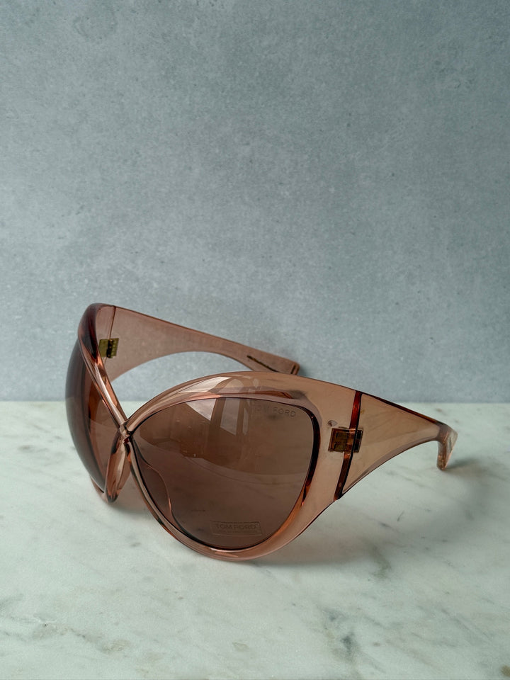 Oversized mask sunglasses with rose-pink frame and brown tinted lenses, no case visible.