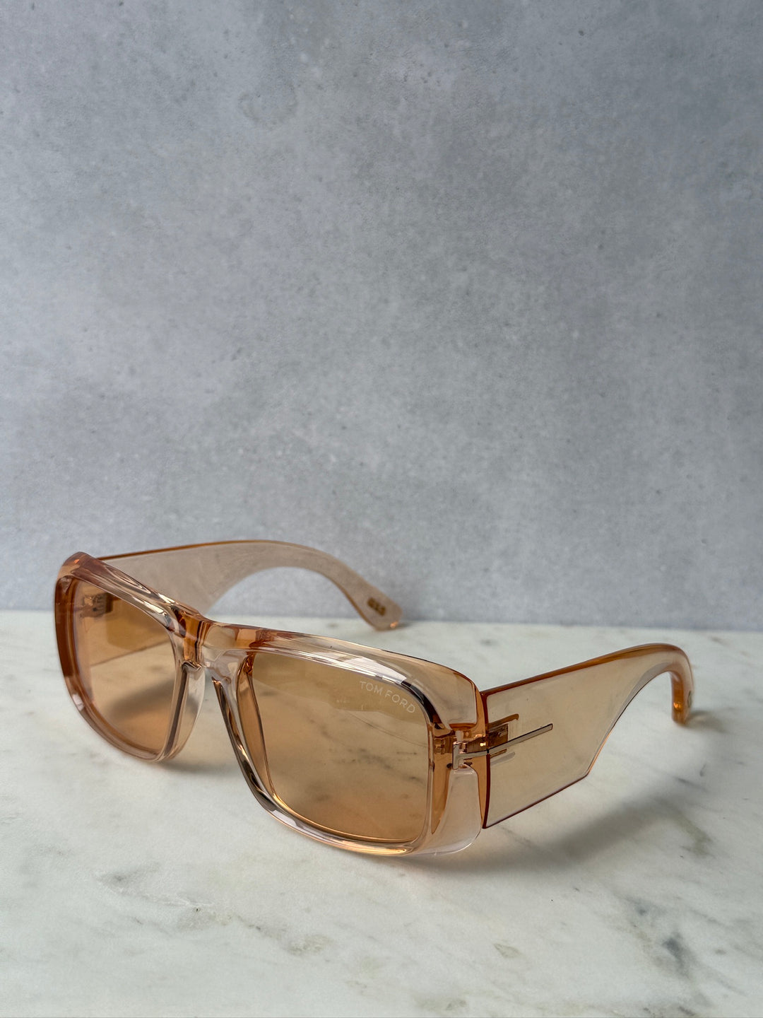 Transparent orange rectangular sunglasses with amber tinted lenses