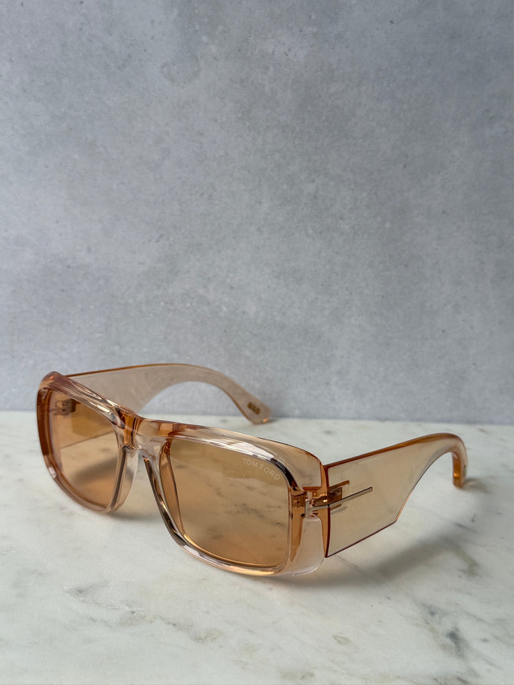 Transparent orange rectangular sunglasses with amber tinted lenses