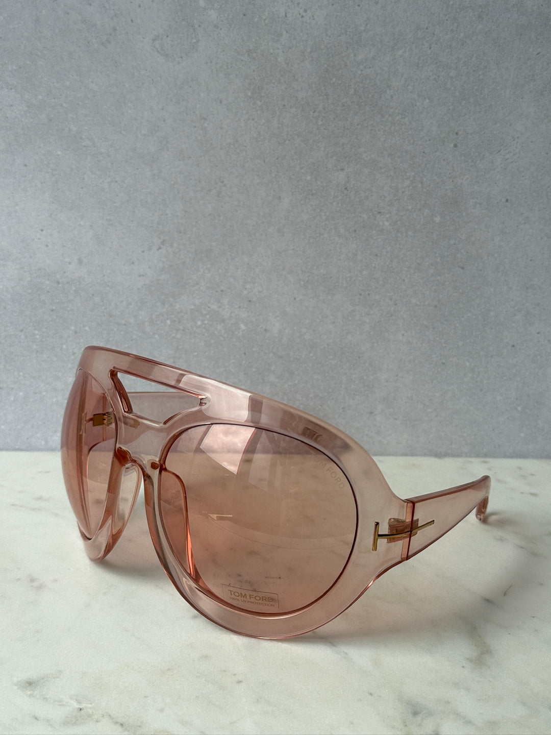 Oversized pink mask sunglasses with tinted lenses and gold-tone frame detailing