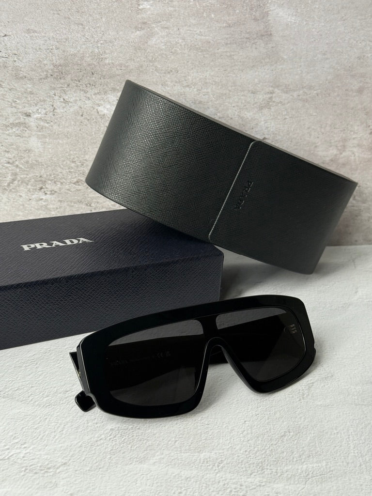Black PRADA sunglasses with dark lenses, thick geometric frame
