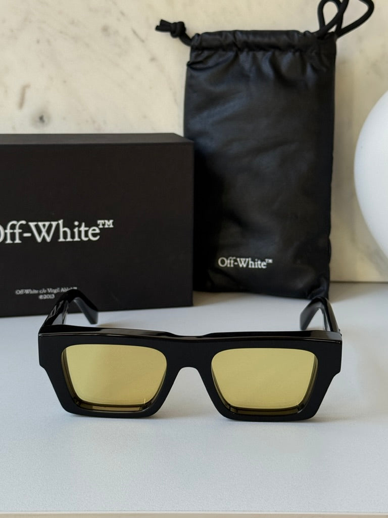 Black rectangular sunglasses with yellow lenses in box with dust bag