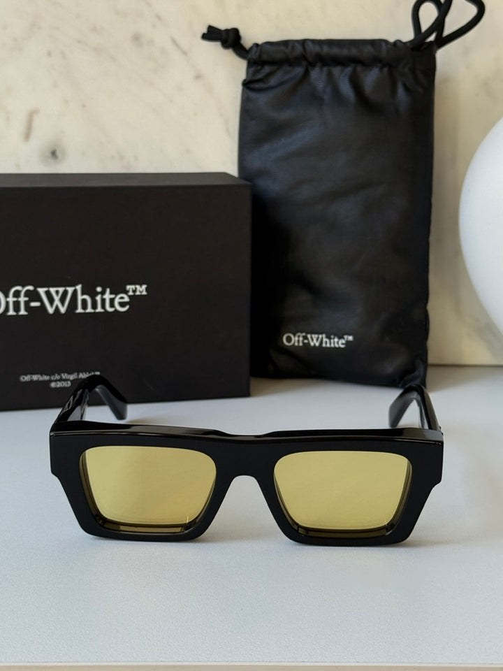 Black rectangular sunglasses with yellow lenses in box with dust bag