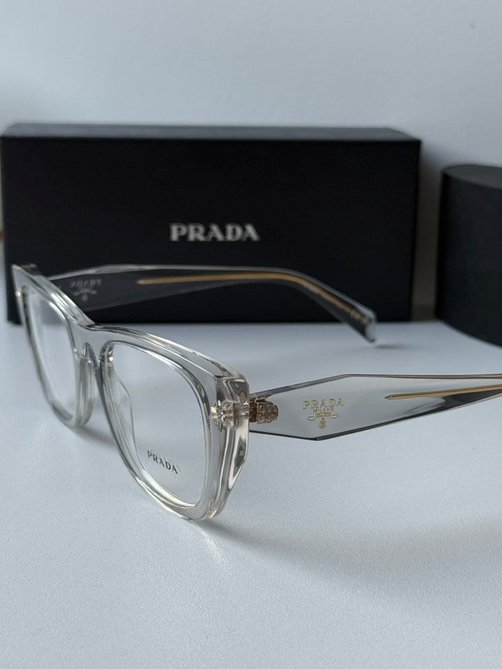 Clear eyeglass frames with gold-tone temple hardware and logo etching
