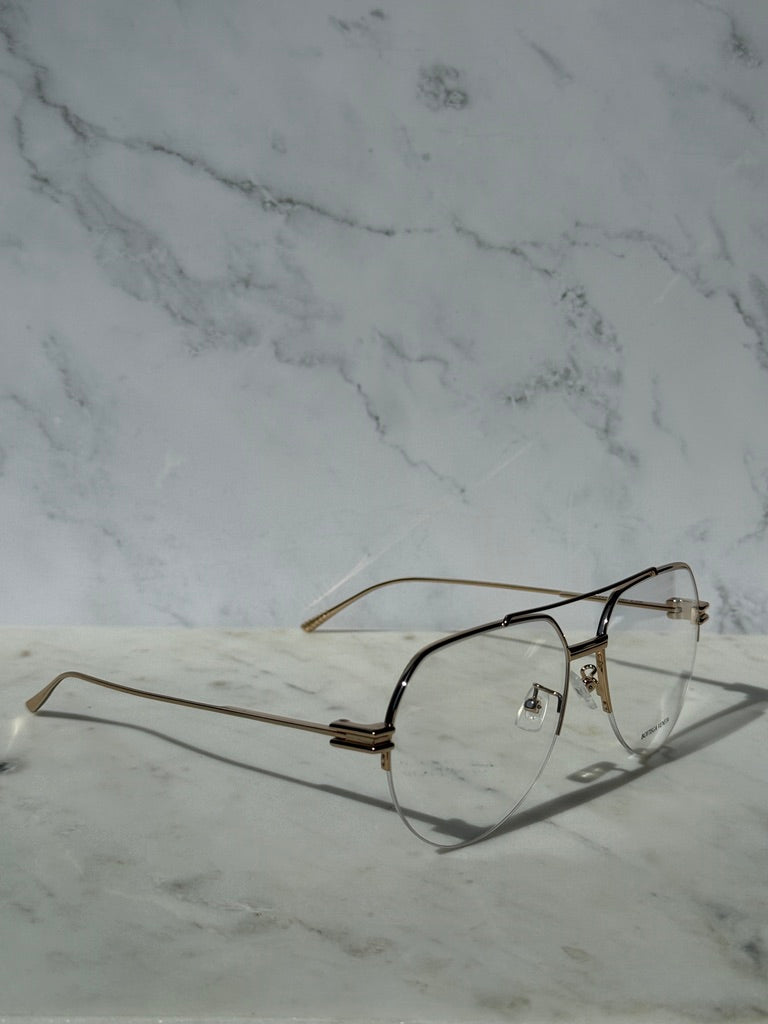 Gold aviator eyeglass frames with clear lenses and dark temple tips