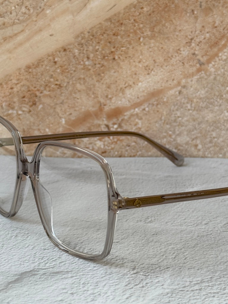Gucci transparent grey eyeglass frames with gold-tone temple detail