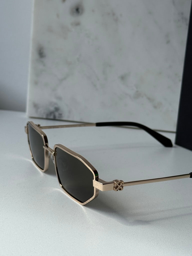 Off-White loa sunglasses side angle with gold frame and dark green lens.
