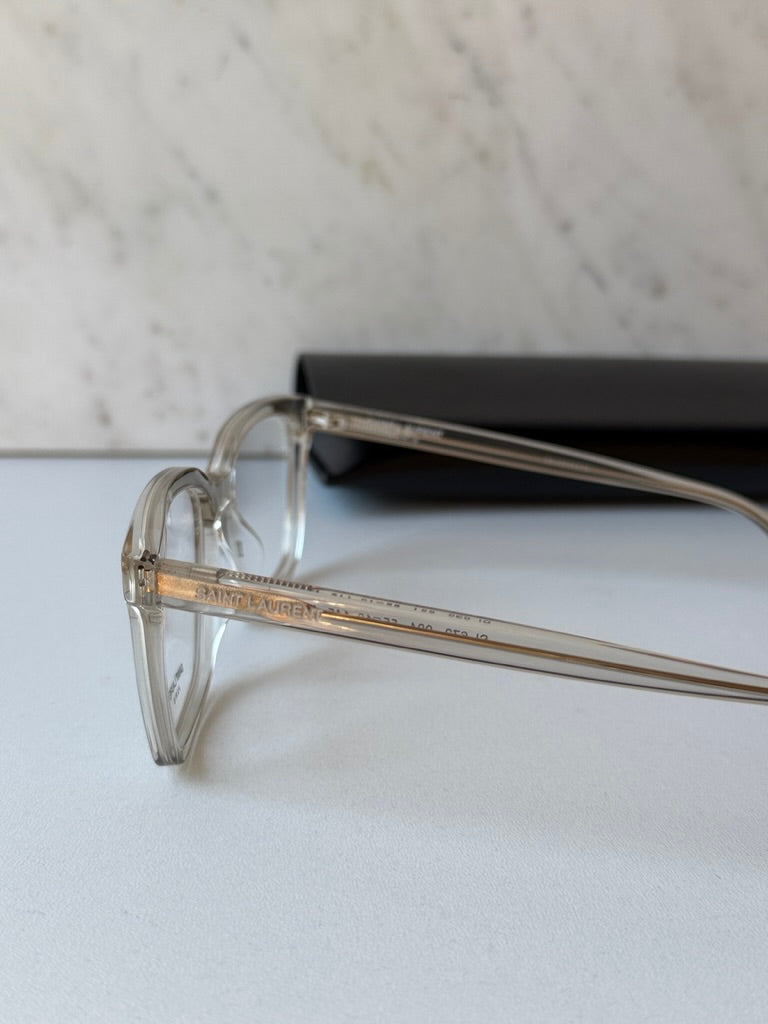 Clear eyeglass frames with engraved temple detail and rectangular front
