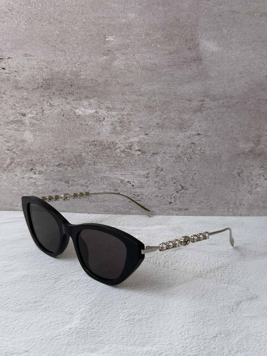 Gucci cat-eye crystal sunglasses, black frame with dark lenses and rhinestone temple
