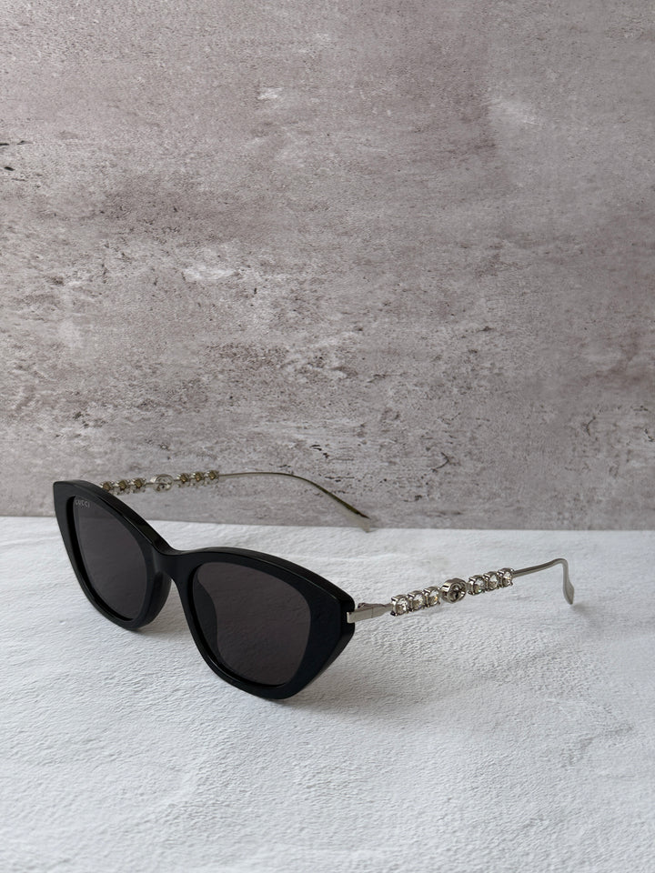 Gucci cat-eye crystal sunglasses, black frame with dark lenses and rhinestone temple