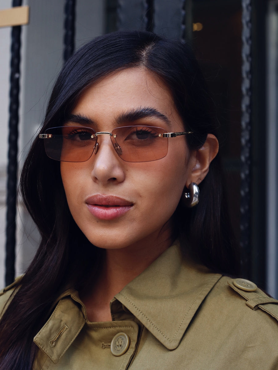 Dior rimless sunglasses with tinted pink lenses and gold-tone frame