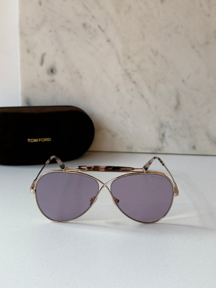 Gold aviator sunglasses with purple tinted lenses, shown with protective case