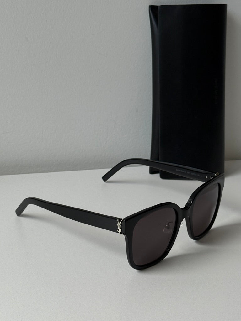 Saint Laurent black cat-eye sunglasses with dark lenses and black storage case