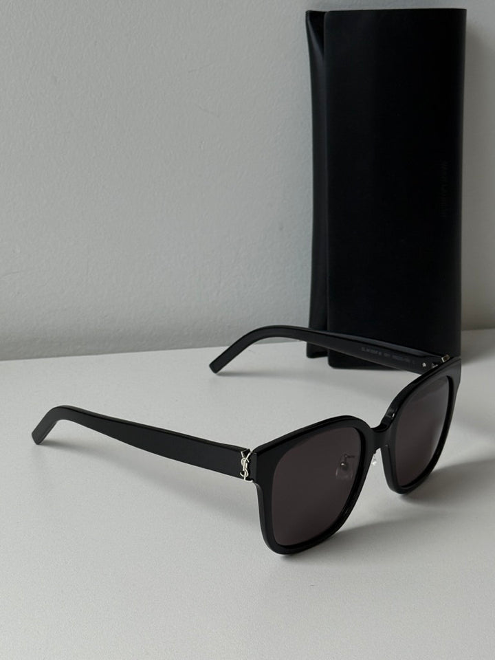 Saint Laurent black cat-eye sunglasses with dark lenses and black storage case