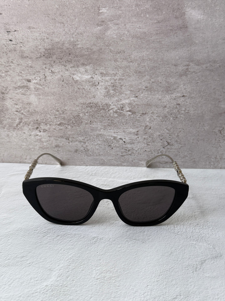 Gucci cat-eye crystal sunglasses, black frames with dark lenses and sparkly temples