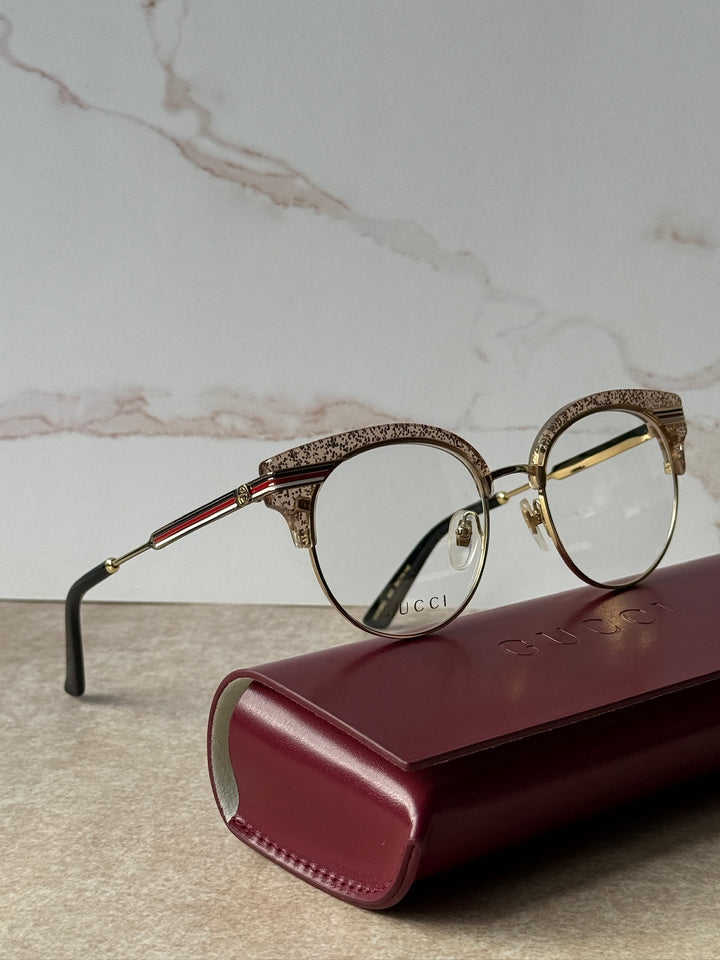 Pink glitter cat-eye eyeglass frames, gold-tone with black temple tips