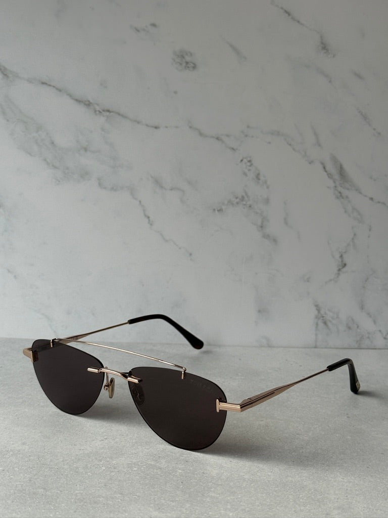 Rose gold aviator sunglasses with dark lenses, thin arms and nose bridge detail