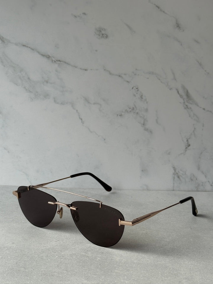 Rose gold aviator sunglasses with dark lenses, thin arms and nose bridge detail