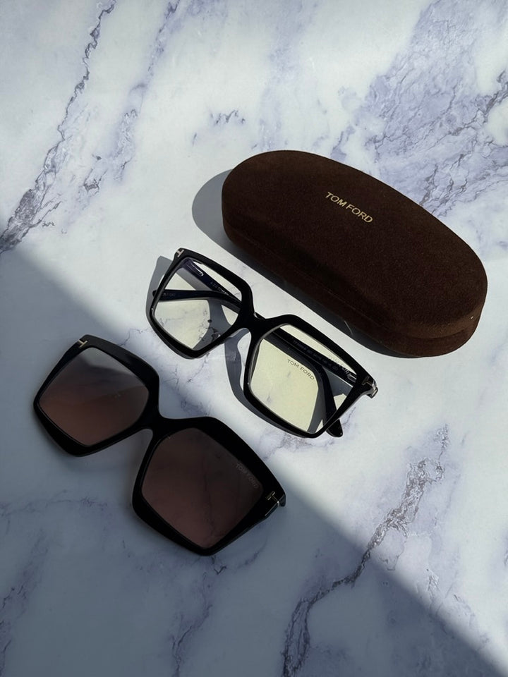 Tom Ford clip-on sunglasses set with black frames, extra lenses, and hard case