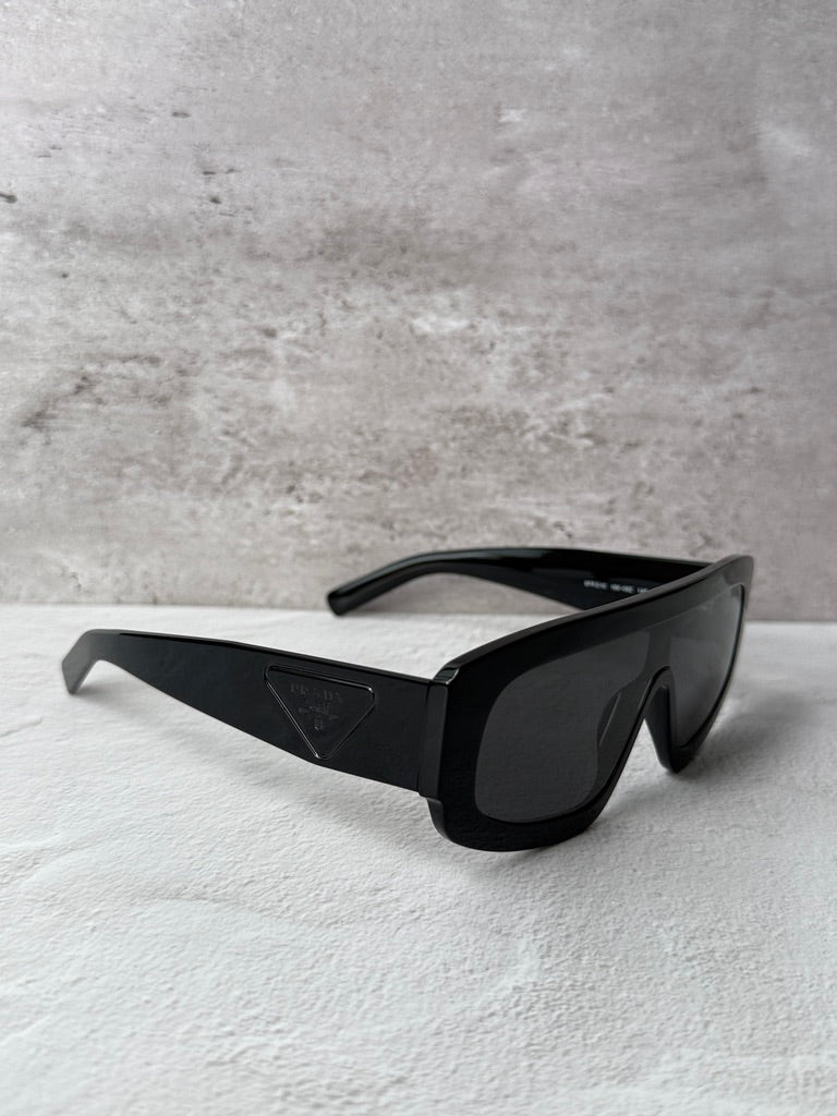 Black PRADA sunglasses with dark lenses and logo on side temple