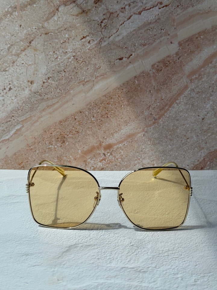 Gucci gold-tone square sunglasses with amber tinted lenses, horizontal view