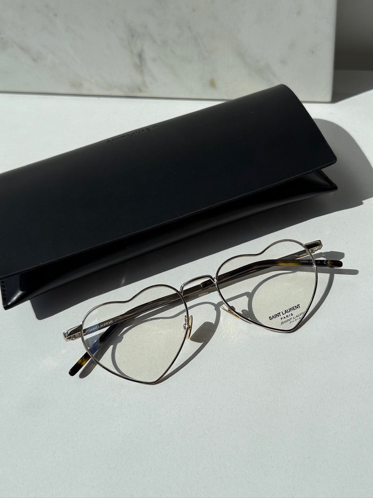 Saint Laurent LouLou optical frames in gold metal with heart-shaped clear lenses, black temples