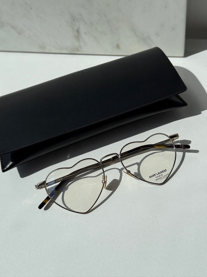 Saint Laurent LouLou optical frames in gold metal with heart-shaped clear lenses, black temples