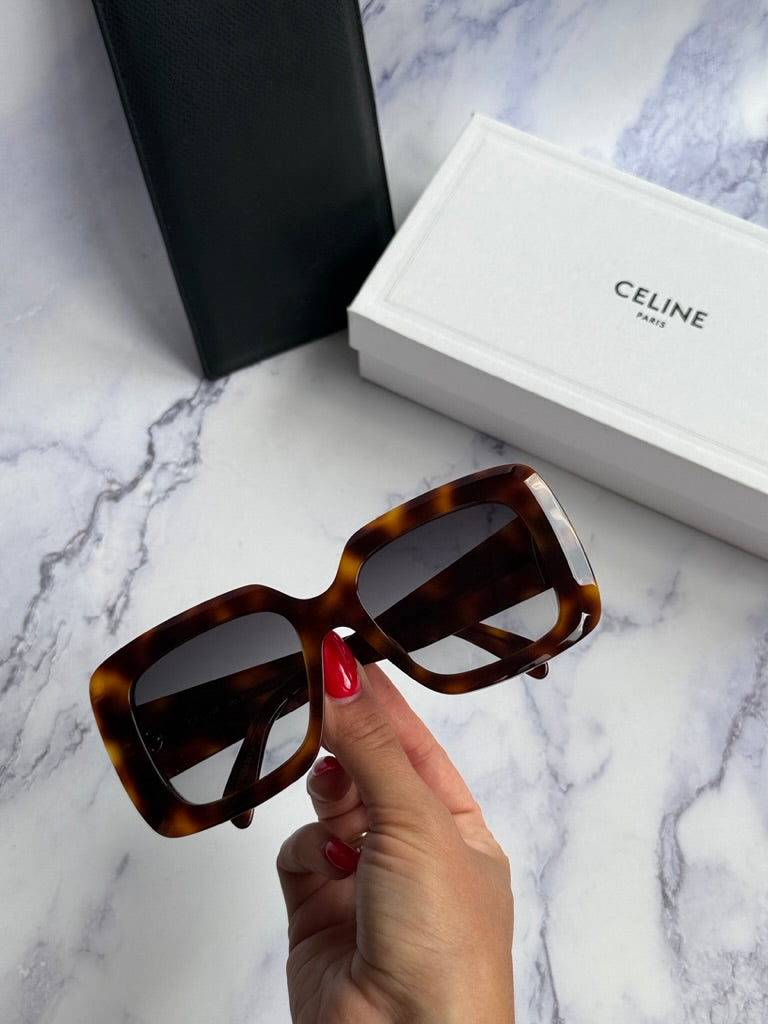 Celine square sunglasses, Havana brown frames, dark lenses held in hand