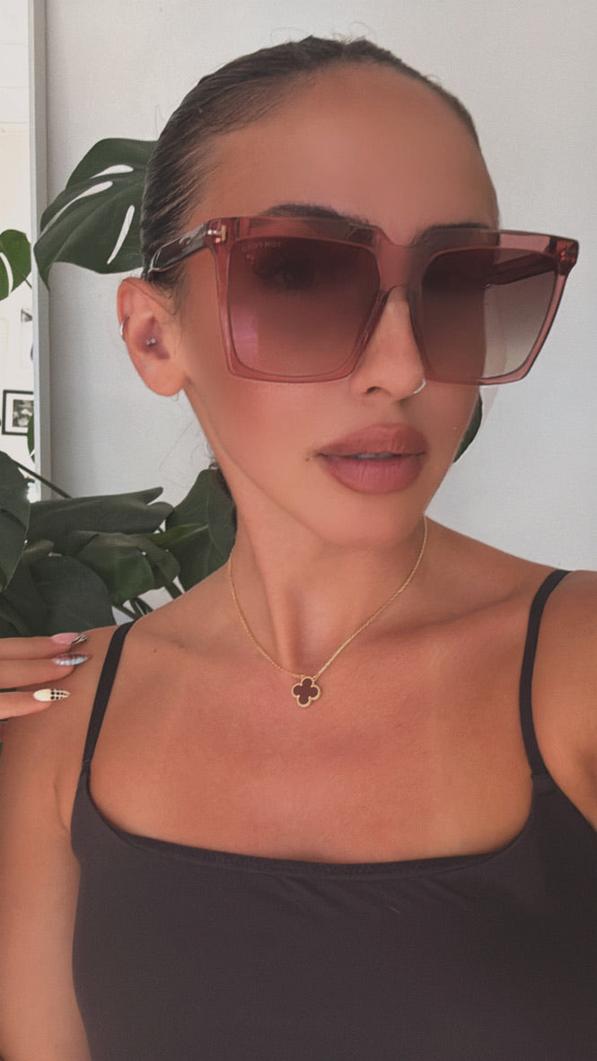 Pink square sunglasses on model, brown gradient lenses and square frame