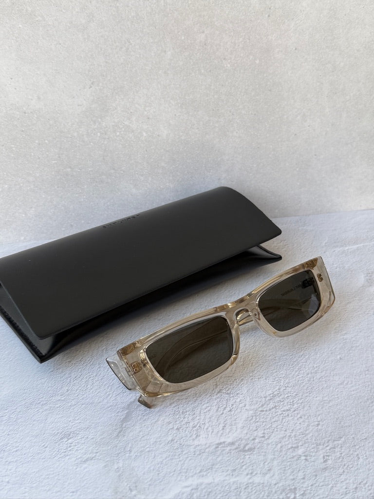 Saint Laurent SL553 slim sunglasses, transparent frame with dark lenses; black case
