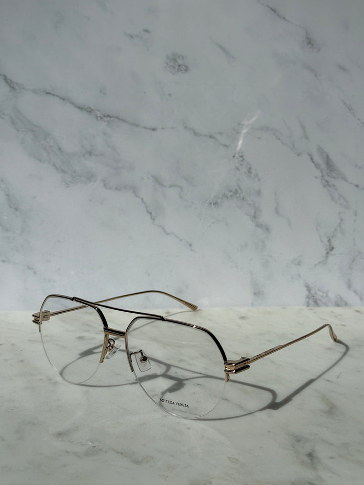 Gold metal aviator eyeglass frames with clear lenses, side view