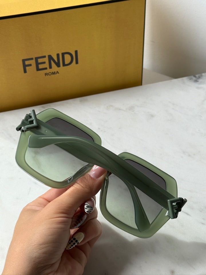 Fendi green sunglasses side view with adjustable temple detail and dark lenses