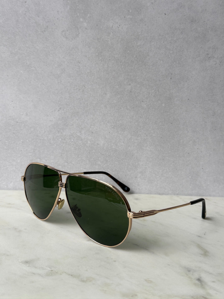 Rose gold aviator sunglasses with dark green lenses and slim metal temples
