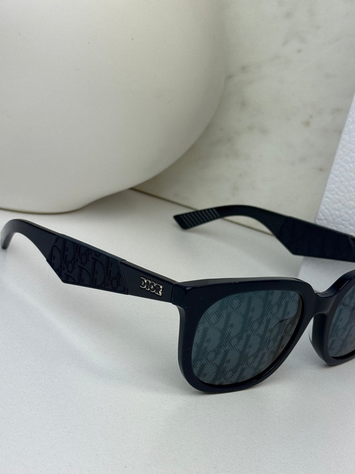 Navy Dior sunglasses with mirror lenses and embossed Dior logo temple, close side view.
