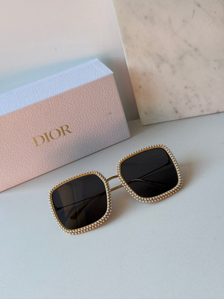 Two pairs of gold rhinestone sunglasses with dark lenses, square cat-eye frames