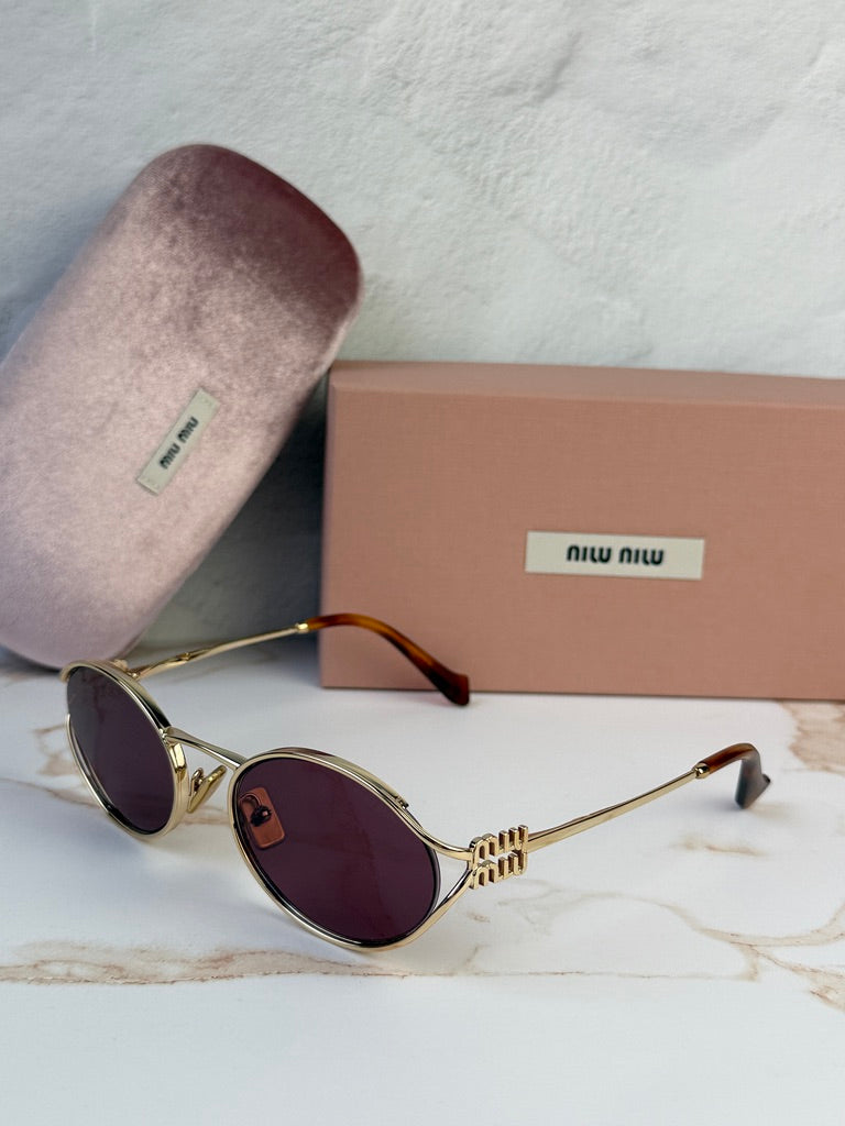 Miu Miu gold oval sunglasses with violet tinted lenses, side view, tortoise temples.