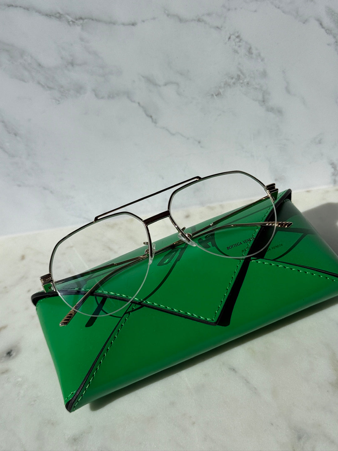 Gold aviator eyeglass frames with clear lenses and dark temples