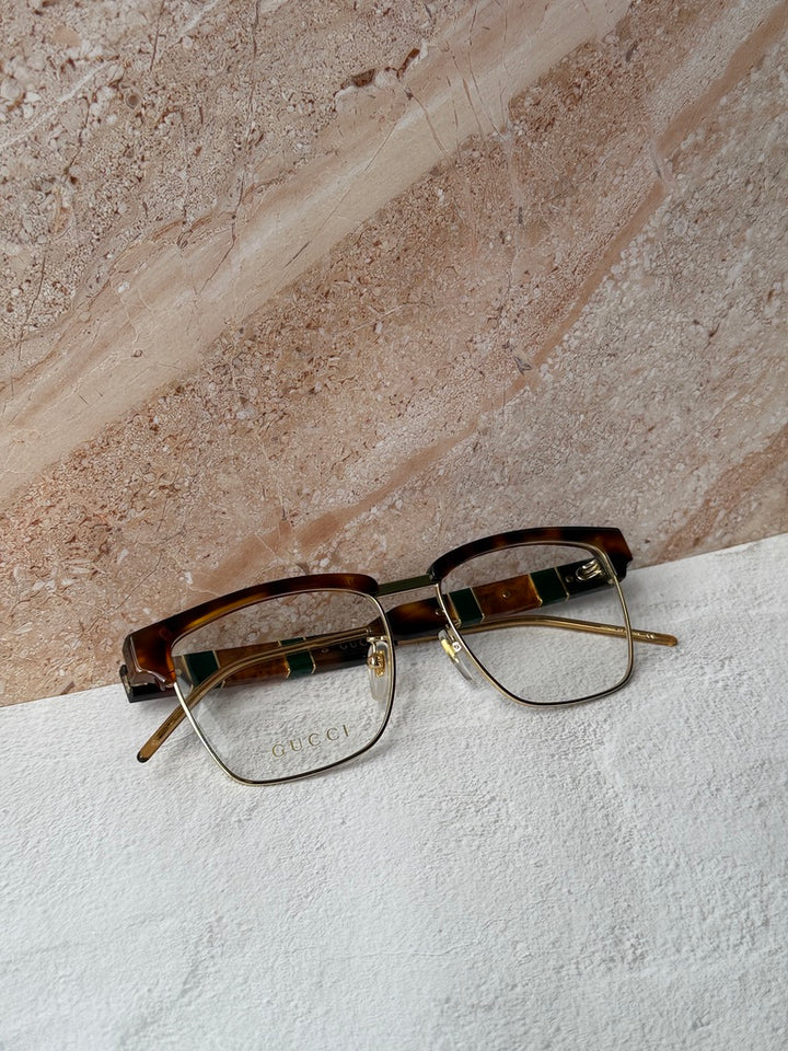 Monturas de anteojos con corte cuadrado extragrande en oro negro Gucci GG0592O
