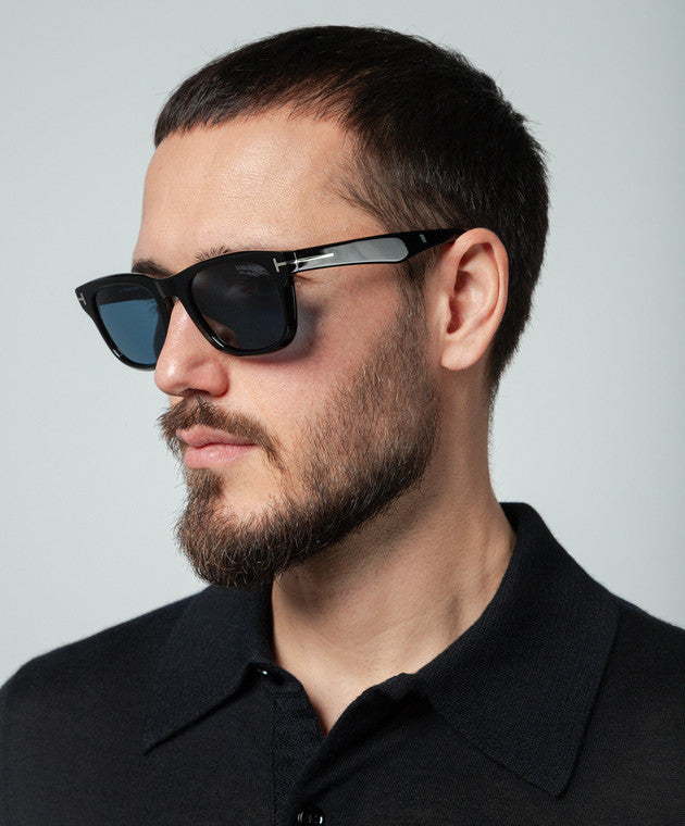 Black sunglasses on model, side view with polarized blue lenses and logo temple