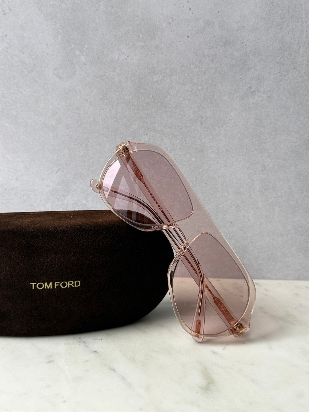 Pink aviator sunglasses with rose-tinted lenses and metal frame, side view