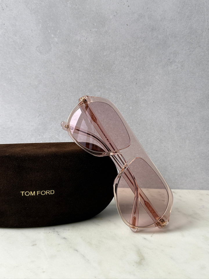Pink aviator sunglasses with rose-tinted lenses and metal frame, side view