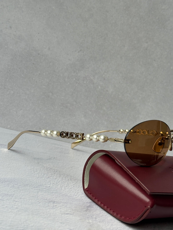 Gucci GG1257S Gafas de sol redondeadas con lentes marrones y rojos