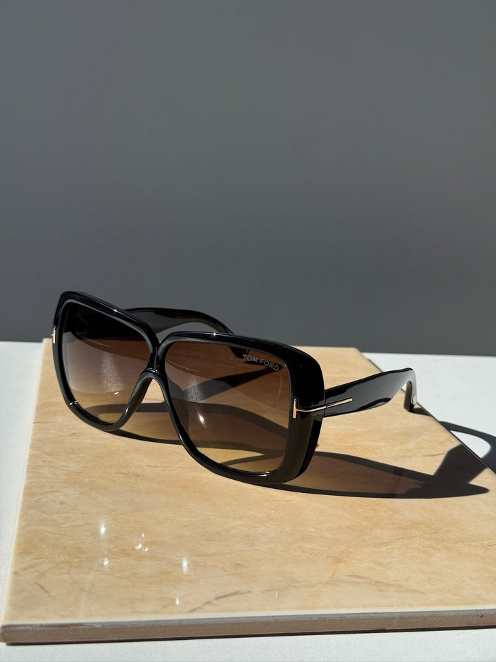 Black square sunglasses with brown-tinted lenses and glossy frames
