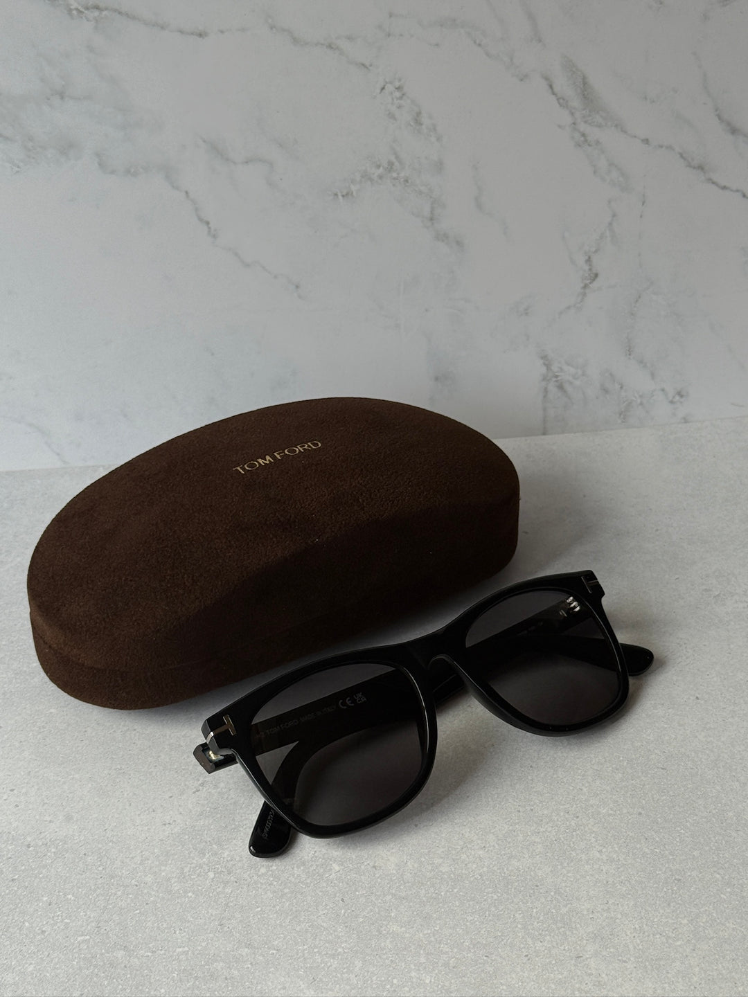 Black polarized rectangular sunglasses with dark lenses and metal logo detail
