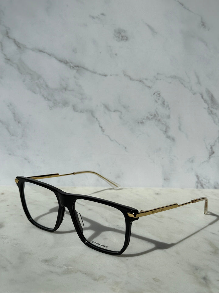 Black rectangular eyeglass frames with thin gold-tone temples and metal hinges.